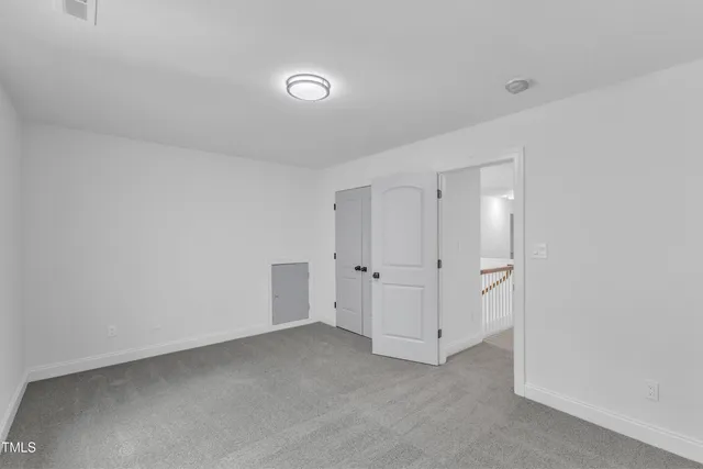 a view of a house with a yard and large trees