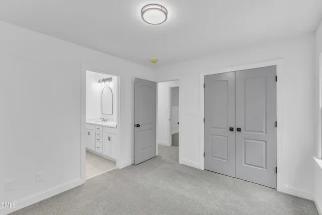 a view of a field with trees in the background