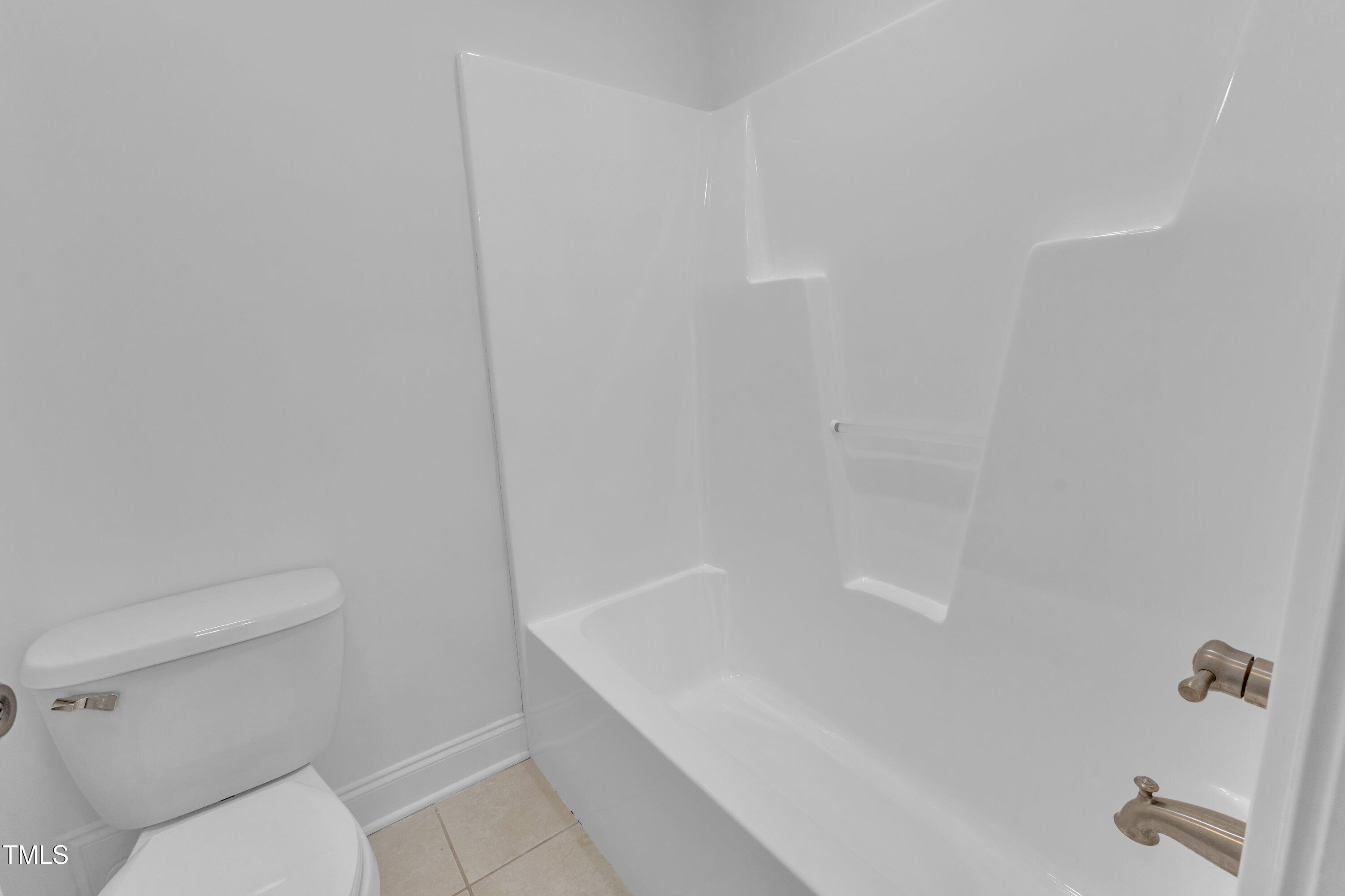 2103 Troys Trail Franklinton, NC 27525 - Photo 37 of 53 a bath room with a toilet and a bath tub