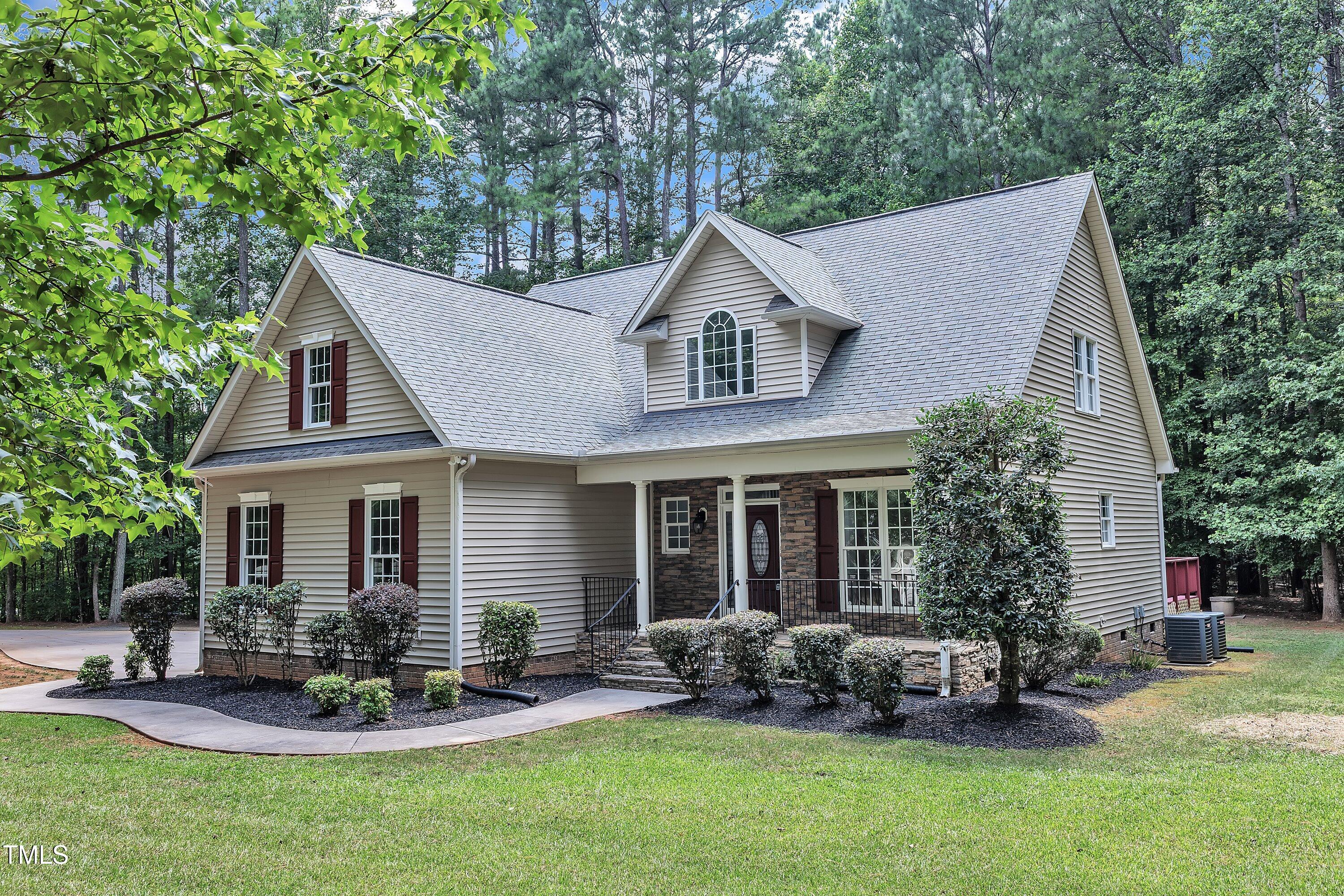 2103 Troys Trail Franklinton, NC 27525 - Photo 42 of 53 a front view of a house with a garden and patio