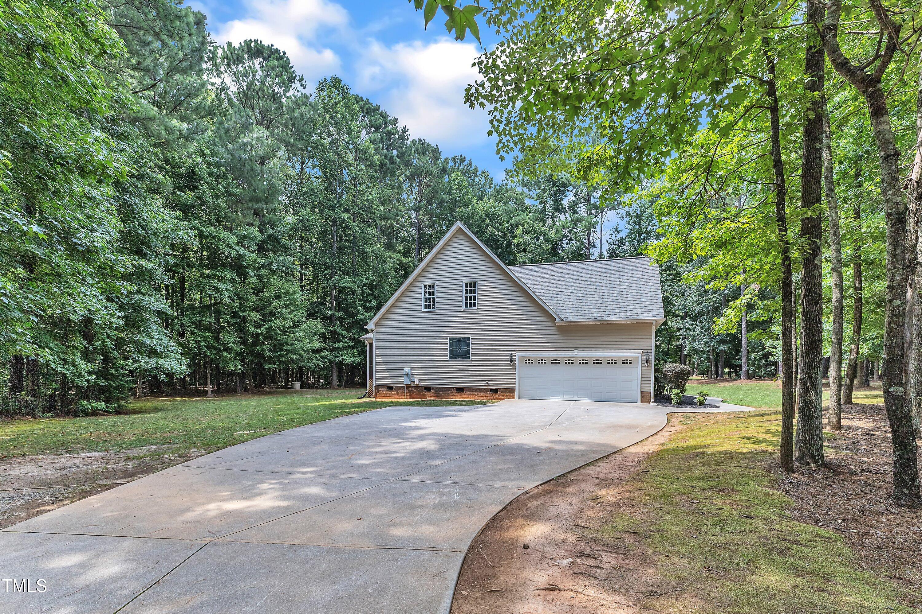 2103 Troys Trail Franklinton, NC 27525 - Photo 47 of 53 a view of a house with a yard and large trees