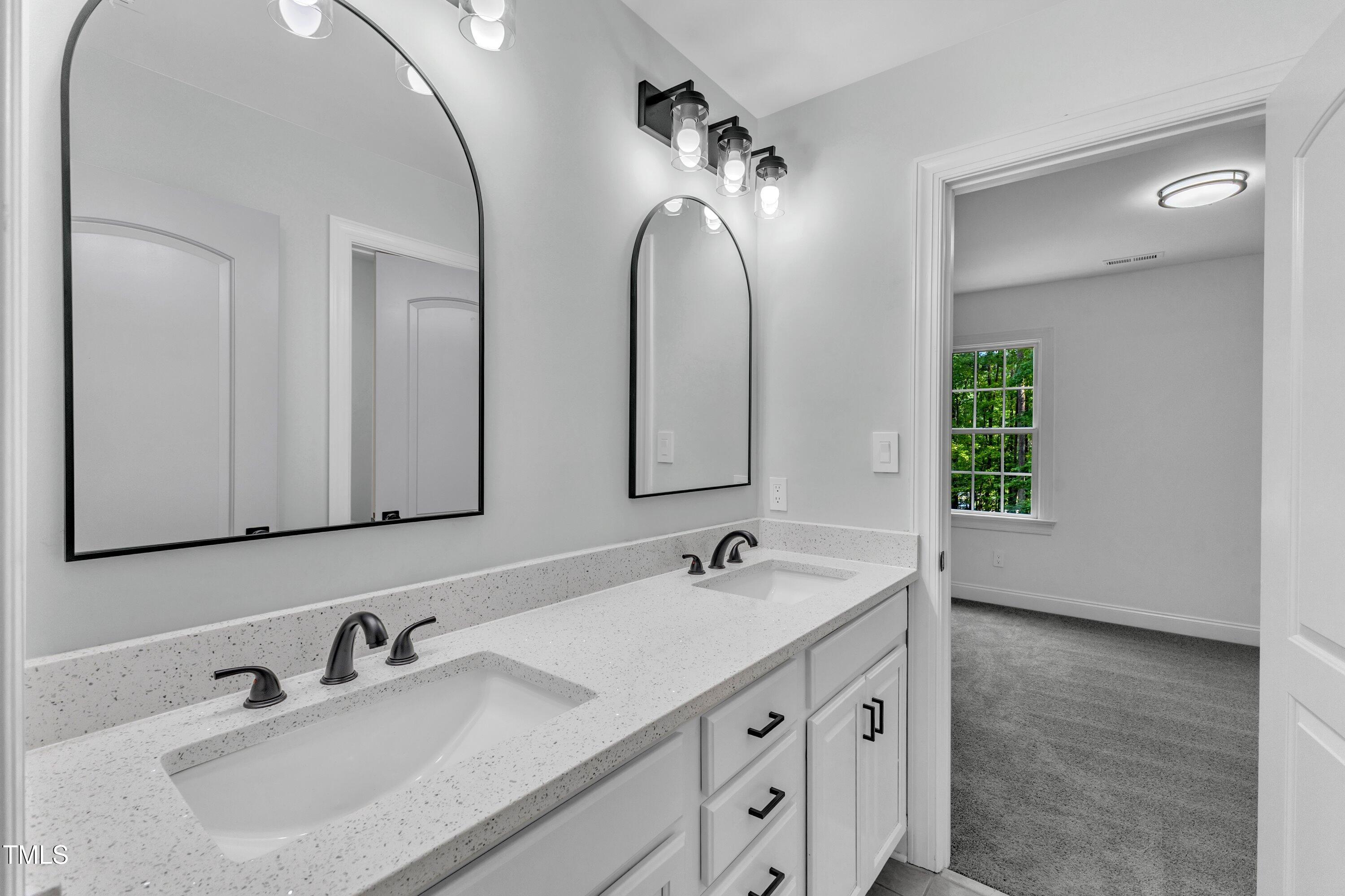 2103 Troys Trail Franklinton, NC 27525 - Photo 5 of 53 a bathroom with a double vanity sink and mirror