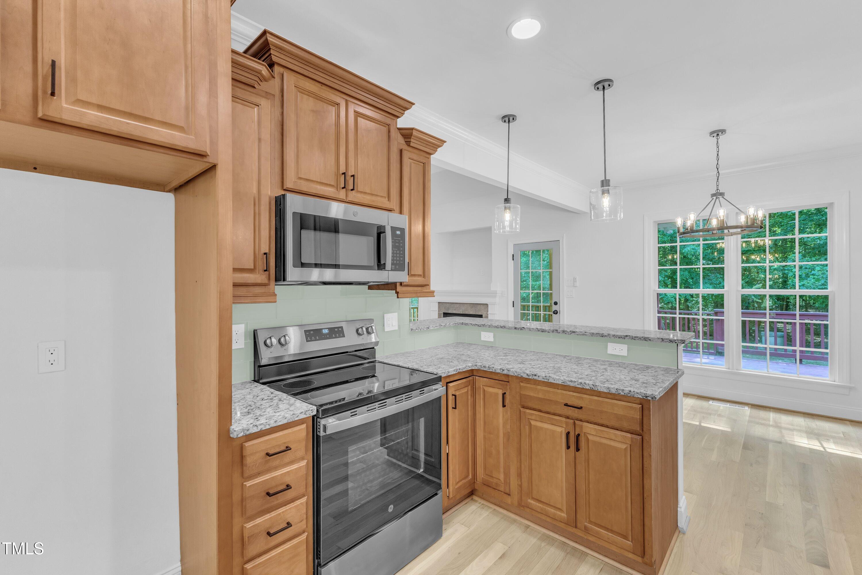 2103 Troys Trail Franklinton, NC 27525 - Photo 8 of 53 a kitchen with stainless steel appliances granite countertop a stove a sink and a microwave