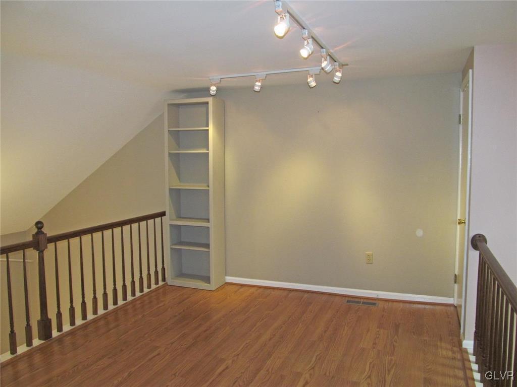 1201 Butztown Road, Unit 22 Bethlehem, PA 18017 - Photo 15 of 23 a view of an empty room with wooden floor and a window