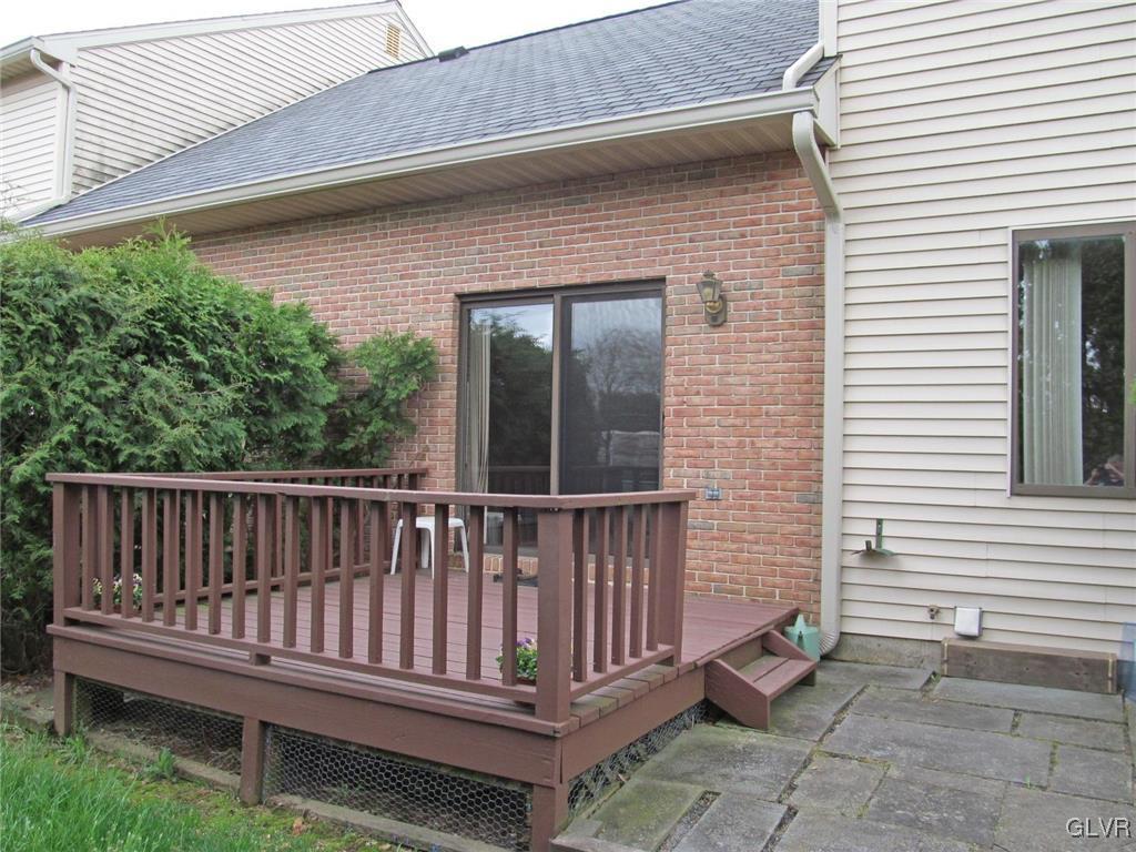 1201 Butztown Road, Unit 22 Bethlehem, PA 18017 - Photo 4 of 23 a view of a deck with a table and chair and wooden floor