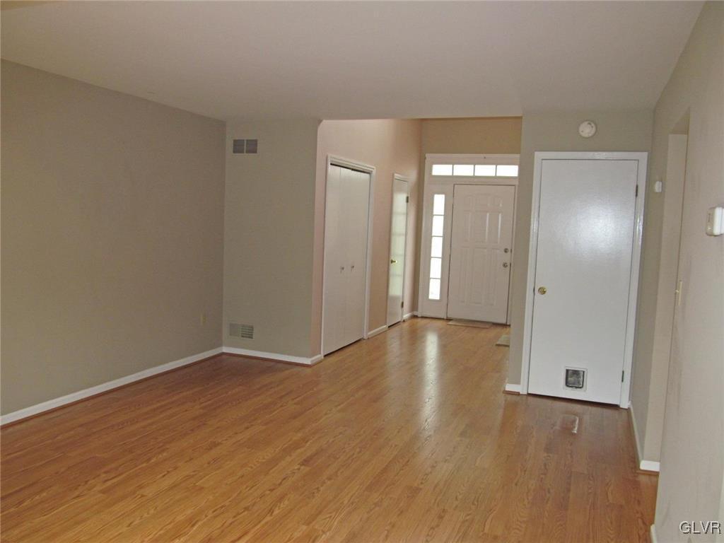 1201 Butztown Road, Unit 22 Bethlehem, PA 18017 - Photo 7 of 23 an empty room with wooden floor and mirror