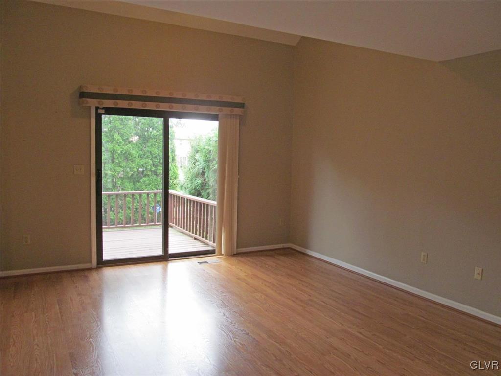 1201 Butztown Road, Unit 22 Bethlehem, PA 18017 - Photo 8 of 23 a view of an empty room with wooden floor and a window