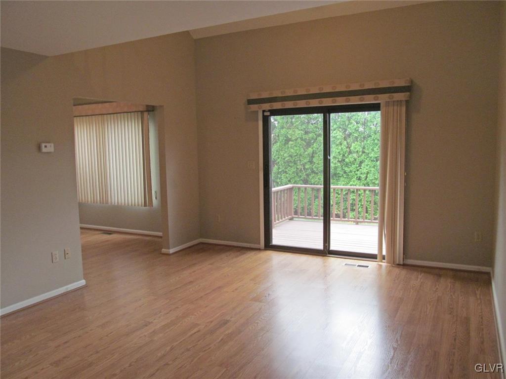 1201 Butztown Road, Unit 22 Bethlehem, PA 18017 - Photo 9 of 23 a view of an empty room with wooden floor and a window
