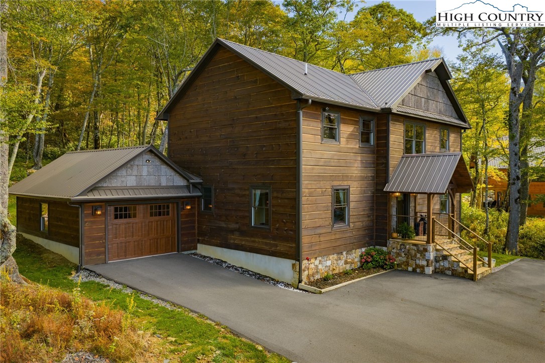 428 Cloud Spring Drive Sugar Mountain, NC 28604 - Photo 1 of 45 a front view of a house with garden
