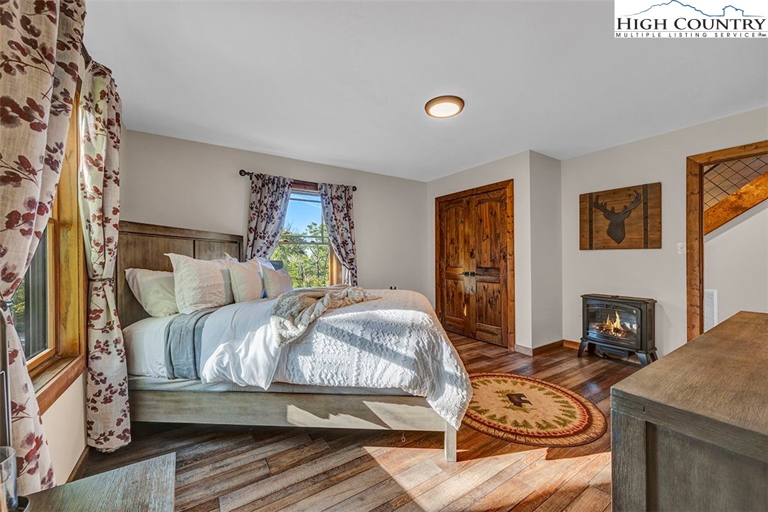 428 Cloud Spring Drive Sugar Mountain, NC 28604 - Photo 13 of 45 a bedroom with a bed and a fireplace