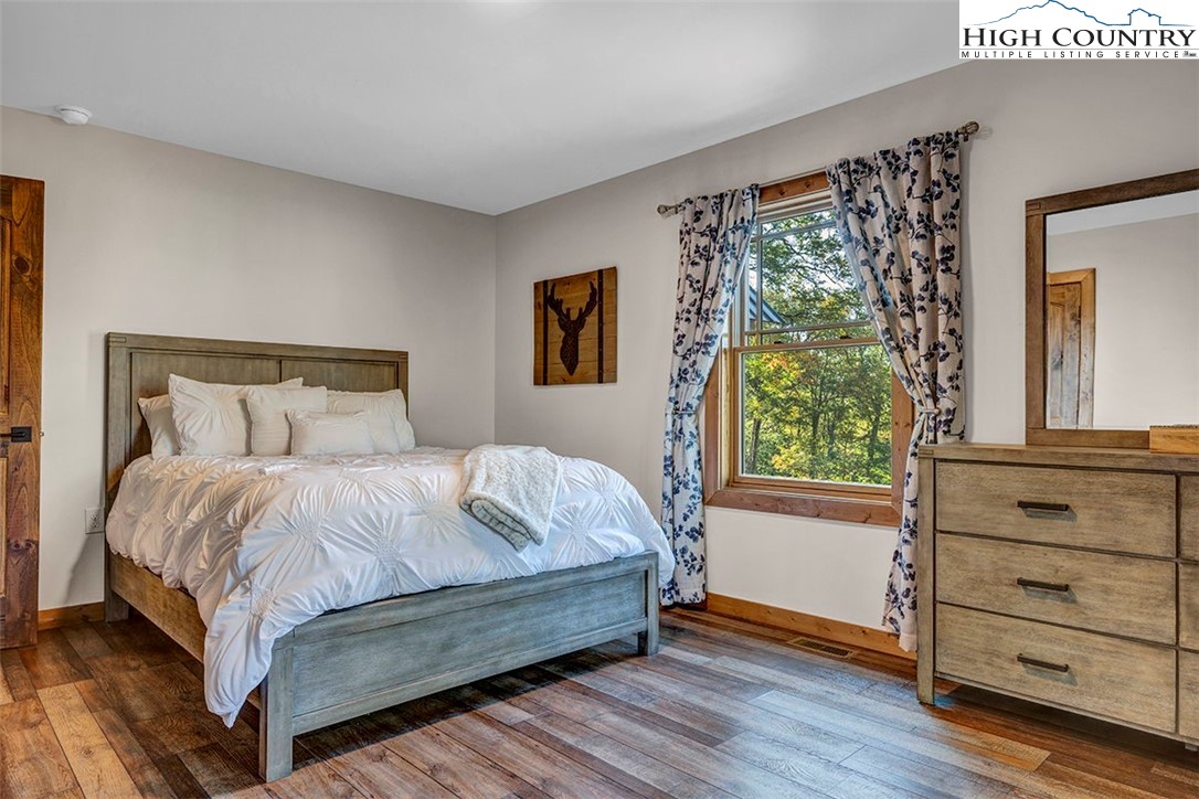 428 Cloud Spring Drive Sugar Mountain, NC 28604 - Photo 18 of 45 a bedroom with a bed and window