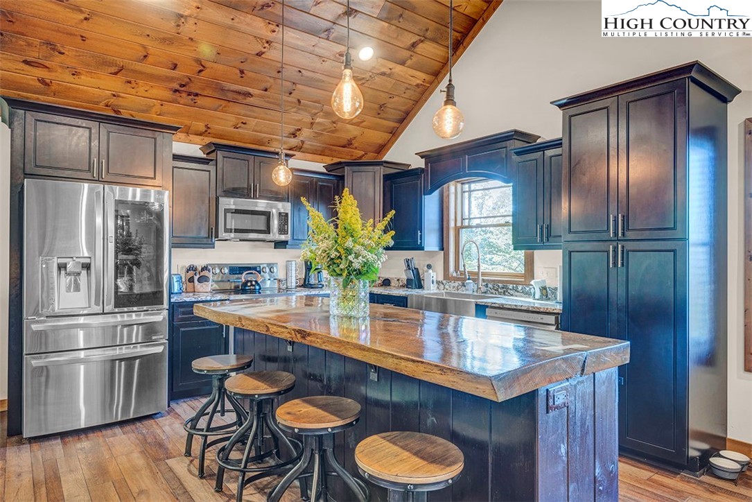 428 Cloud Spring Drive Sugar Mountain, NC 28604 - Photo 21 of 45 a kitchen with stainless steel appliances granite countertop a sink a stove and refrigerator
