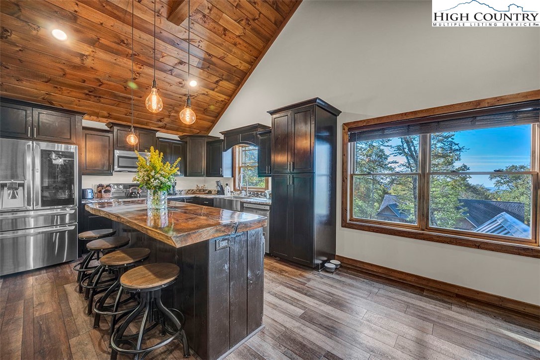 428 Cloud Spring Drive Sugar Mountain, NC 28604 - Photo 23 of 45 a kitchen with stainless steel appliances granite countertop a sink and a refrigerator
