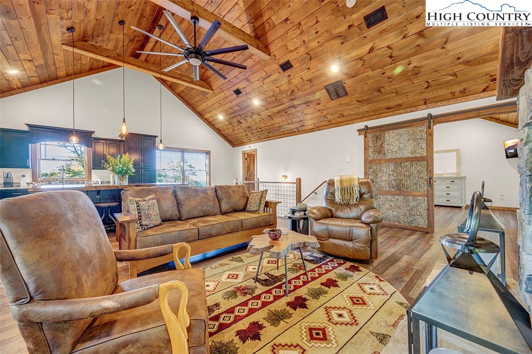 428 Cloud Spring Drive Sugar Mountain, NC 28604 - Photo 27 of 45 a media room with lots of chairs and a wooden floor