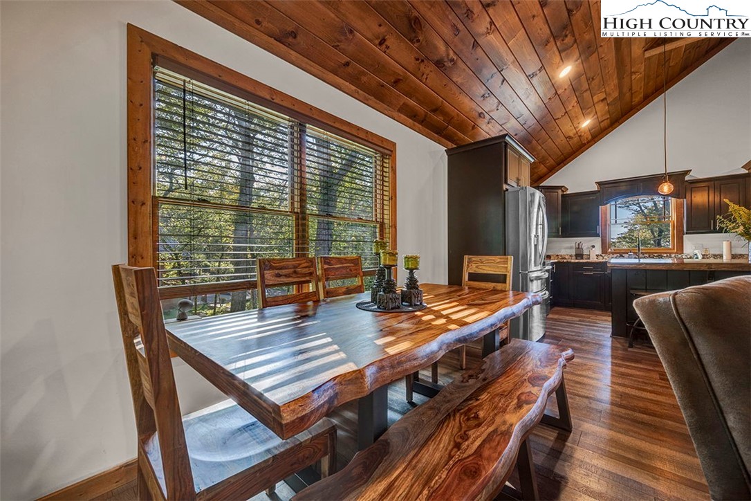 428 Cloud Spring Drive Sugar Mountain, NC 28604 - Photo 29 of 45 a view of a dining room with furniture window and wooden floor