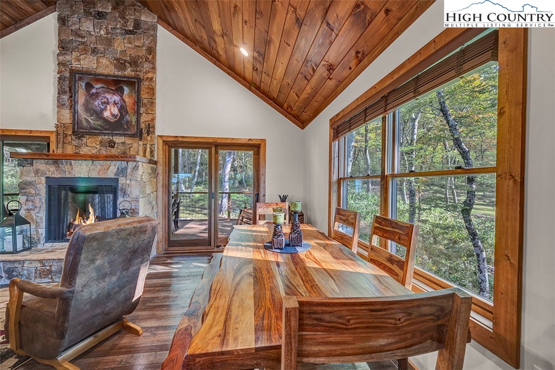 428 Cloud Spring Drive Sugar Mountain, NC 28604 - Photo 30 of 45 a living room with furniture a fireplace and a large window