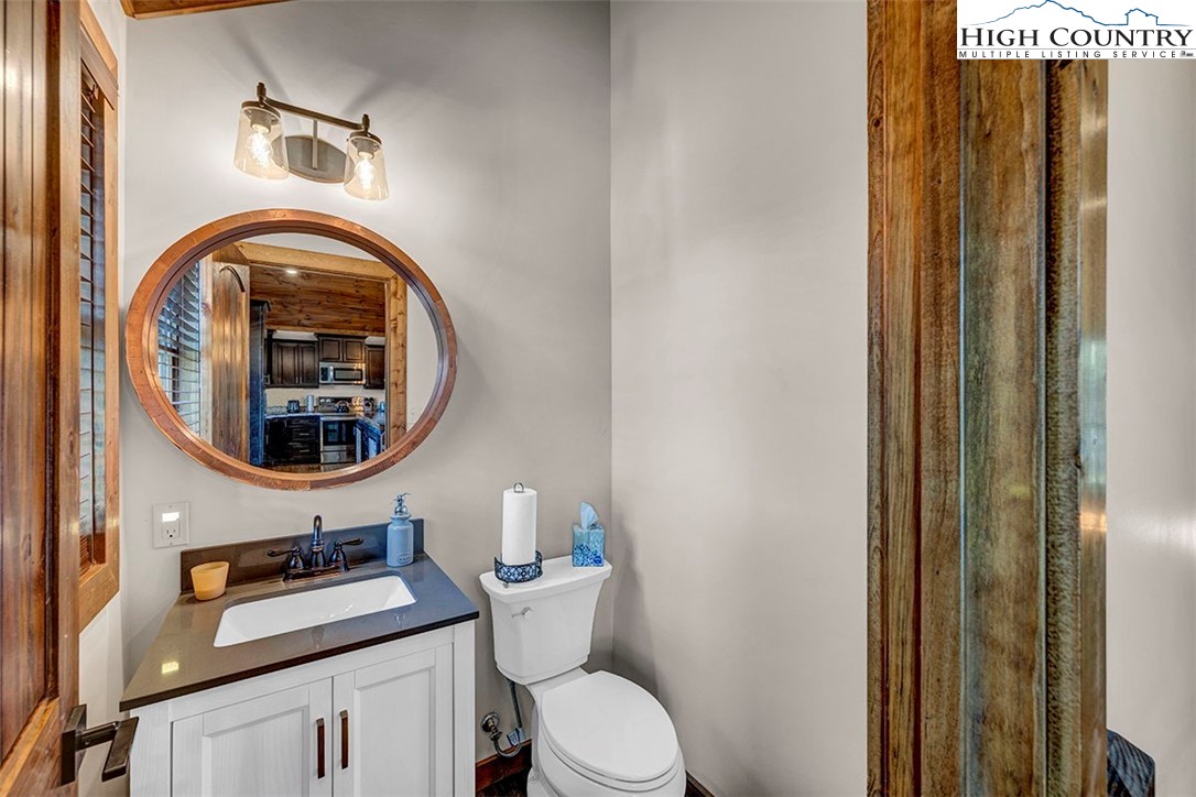 428 Cloud Spring Drive Sugar Mountain, NC 28604 - Photo 31 of 45 a bathroom with a toilet a sink and a mirror