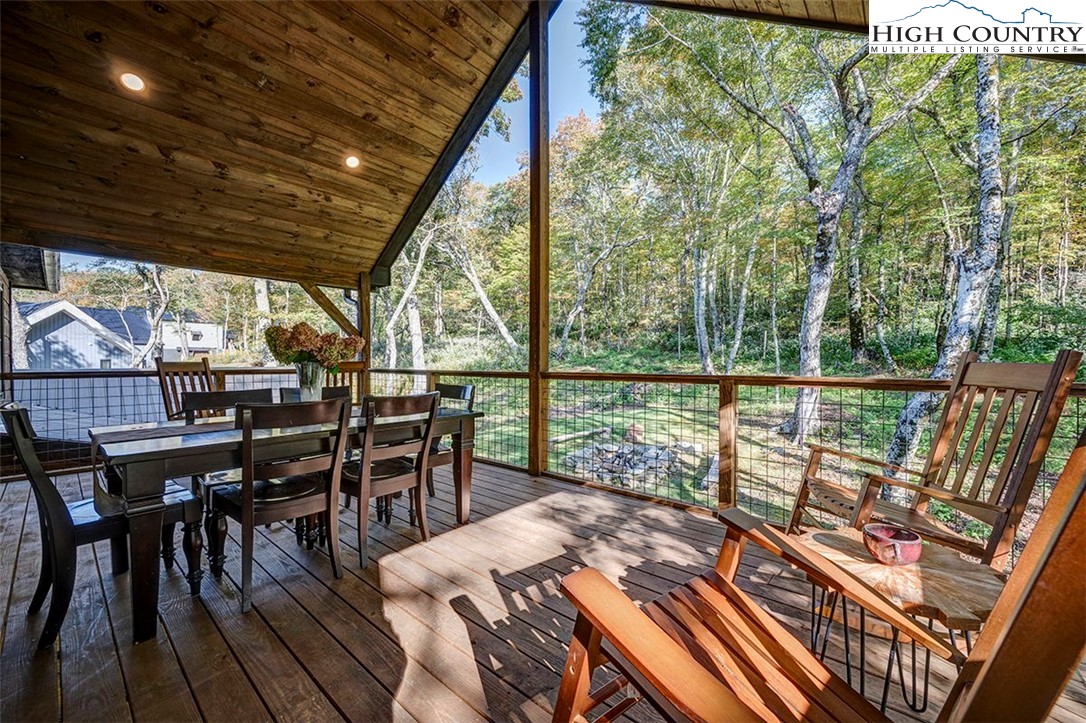 428 Cloud Spring Drive Sugar Mountain, NC 28604 - Photo 33 of 45 a view of a balcony with chairs and wooden floor