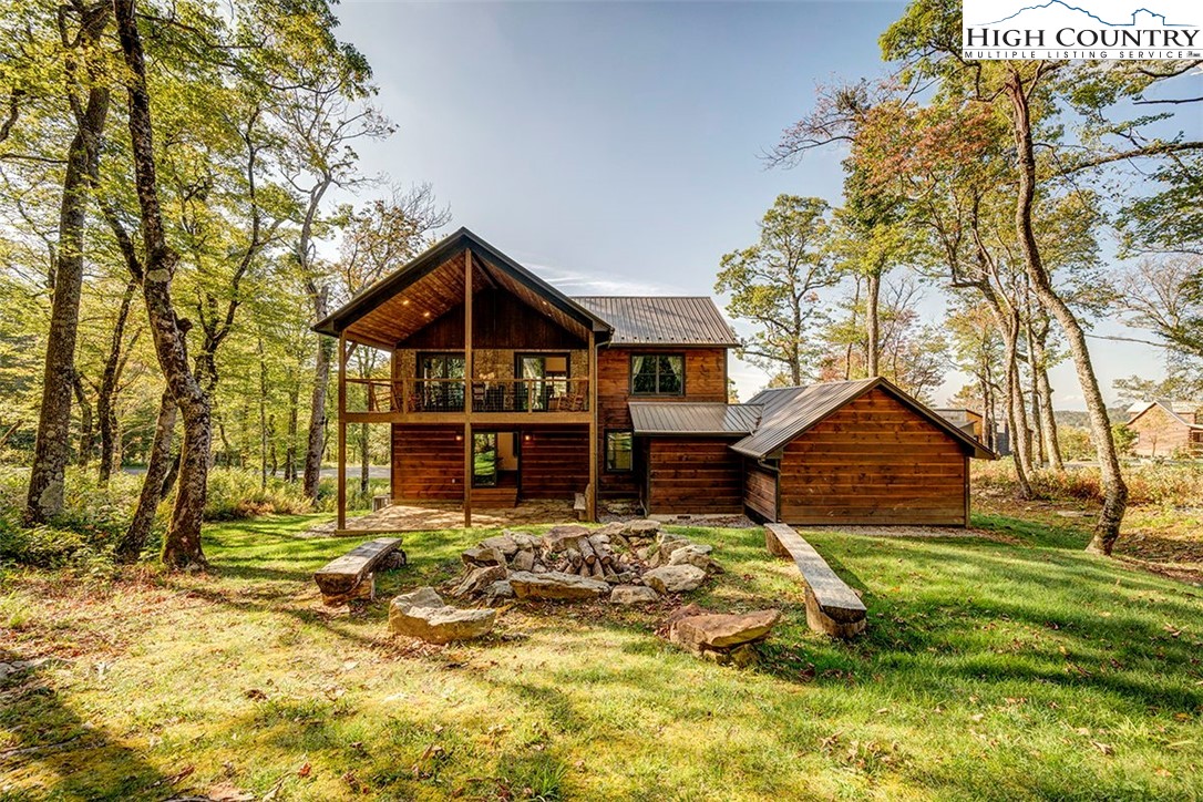 428 Cloud Spring Drive Sugar Mountain, NC 28604 - Photo 42 of 45 a front view of a house with a yard table and chairs