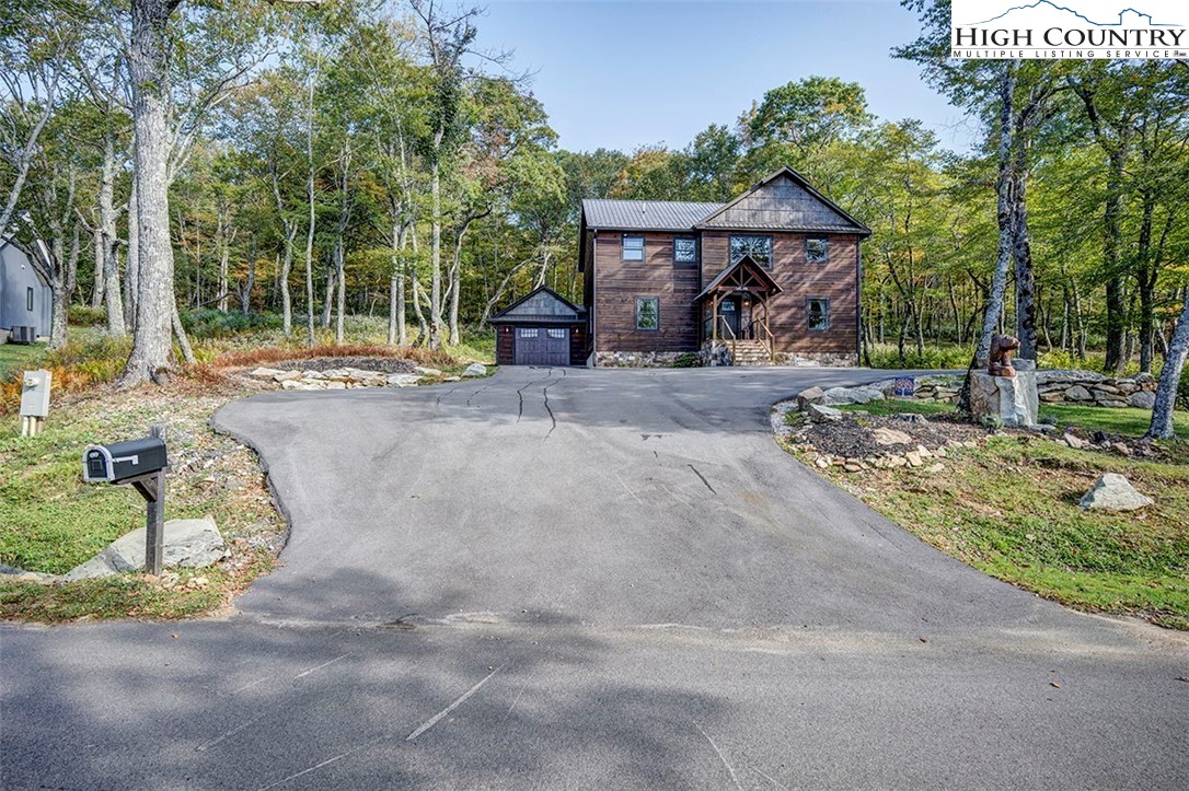 428 Cloud Spring Drive Sugar Mountain, NC 28604 - Photo 43 of 45 a front view of a house with garden