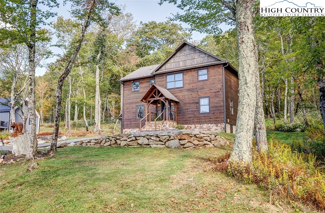428 Cloud Spring Drive Sugar Mountain, NC 28604 - Photo 44 of 45 a front view of a house with garden