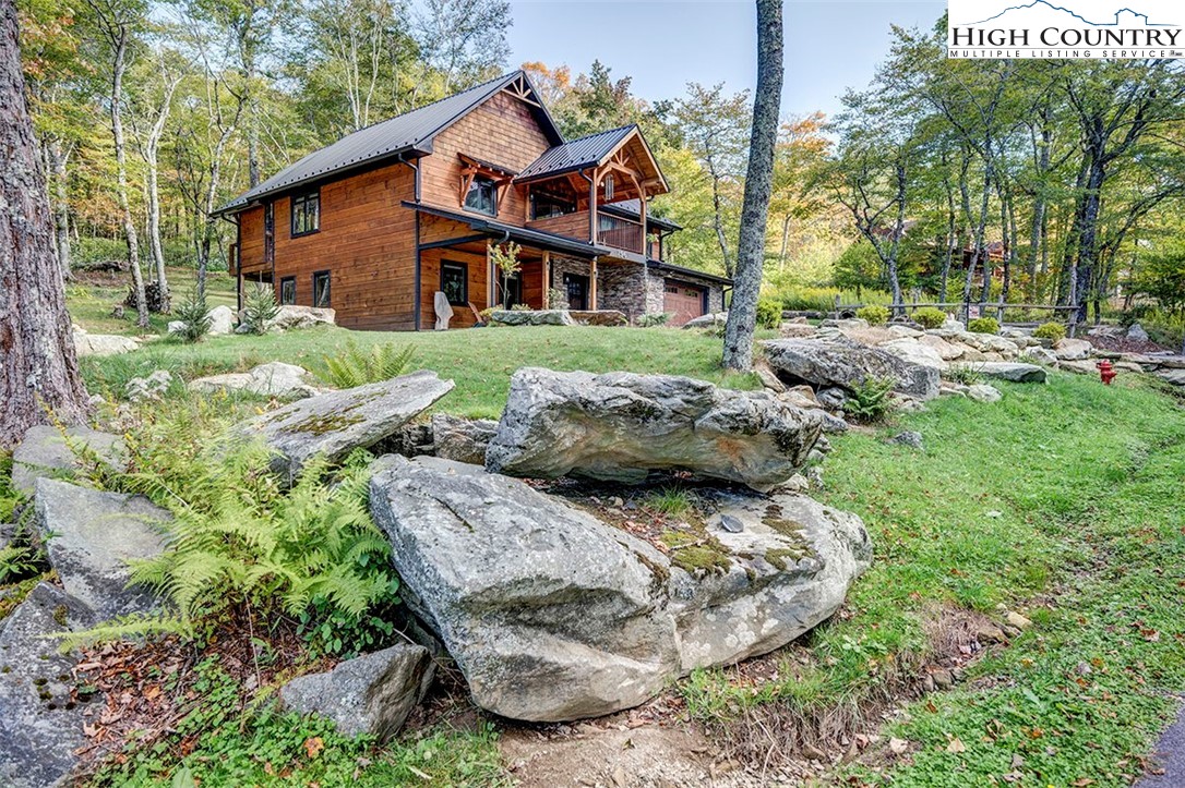 428 Cloud Spring Drive Sugar Mountain, NC 28604 - Photo 45 of 45 a front view of a house with garden