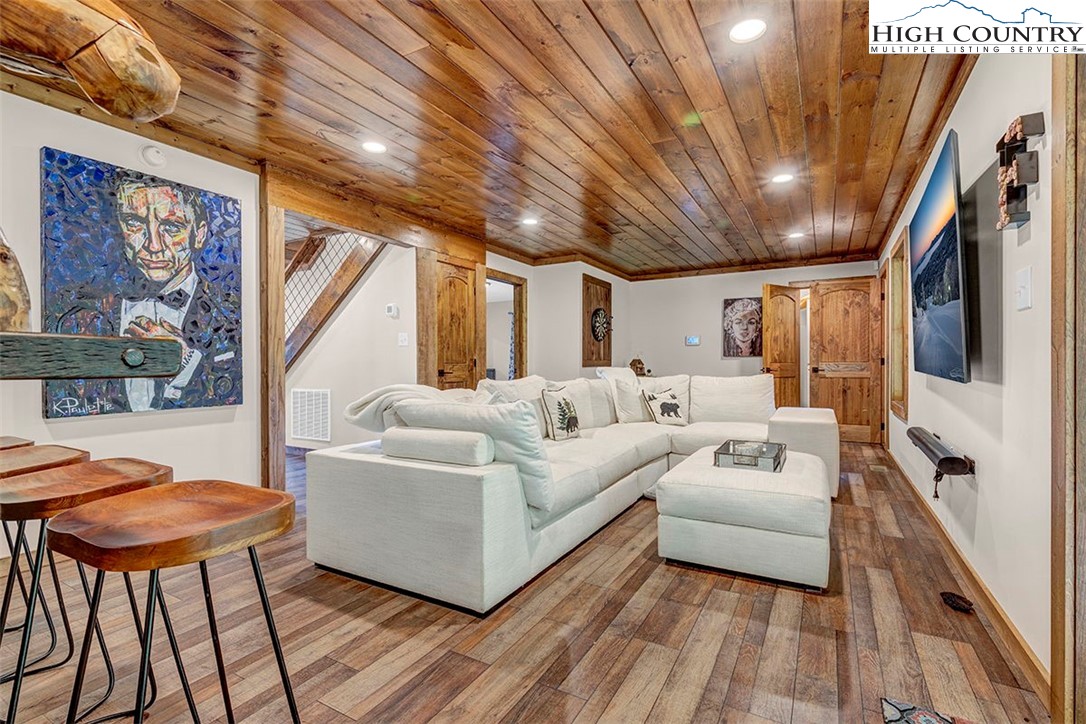 428 Cloud Spring Drive Sugar Mountain, NC 28604 - Photo 6 of 45 a living room with furniture a flat screen tv and a table