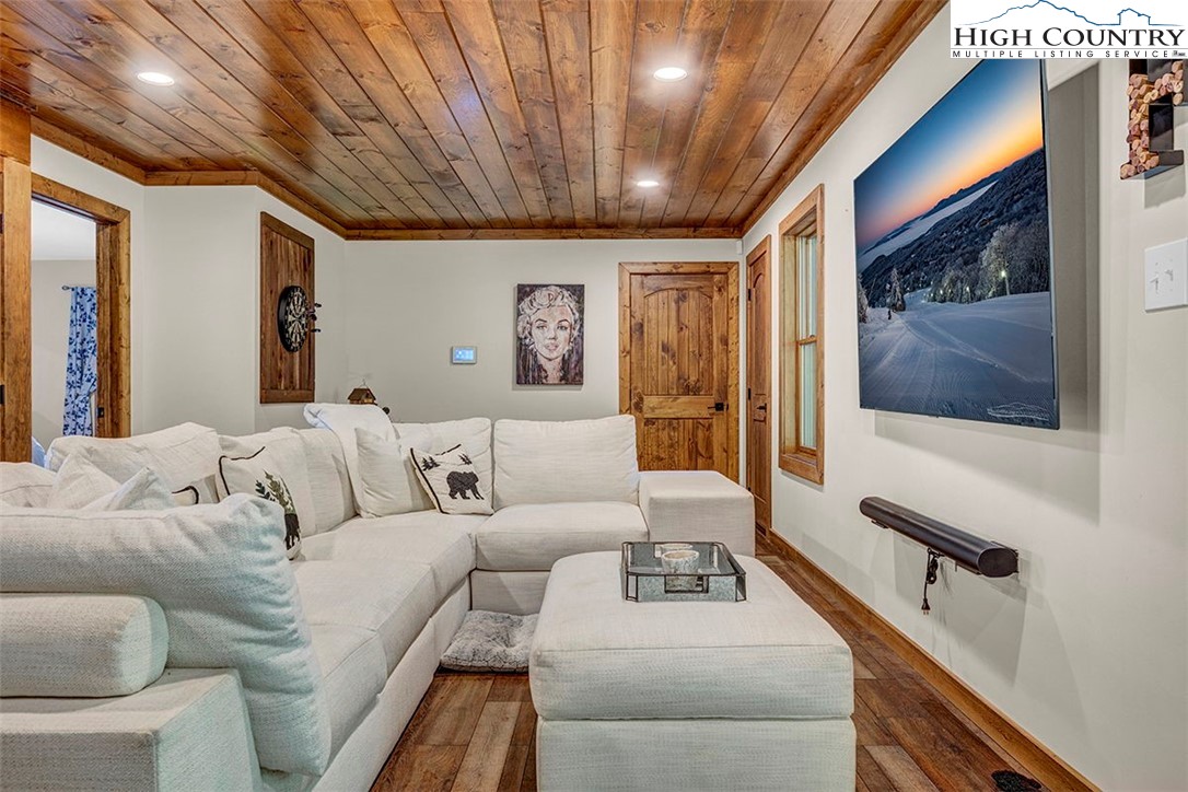 428 Cloud Spring Drive Sugar Mountain, NC 28604 - Photo 10 of 45 a living room with furniture and a flat screen tv