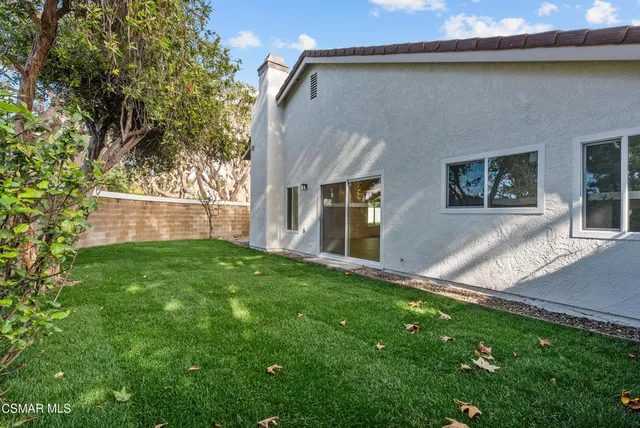 a view of backyard with seating area and green space