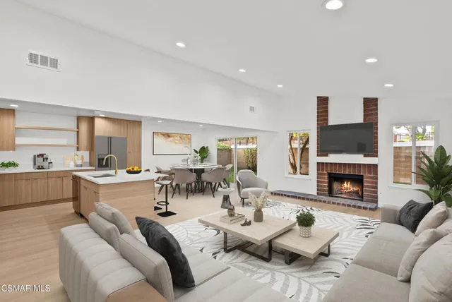 a living room with fireplace furniture and a fireplace