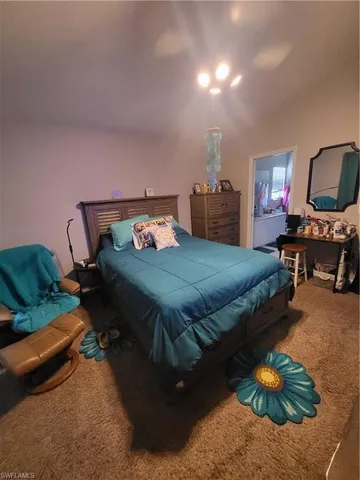 a bedroom with bed and a couch