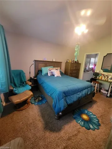 a bedroom with furniture and a painting on the wall