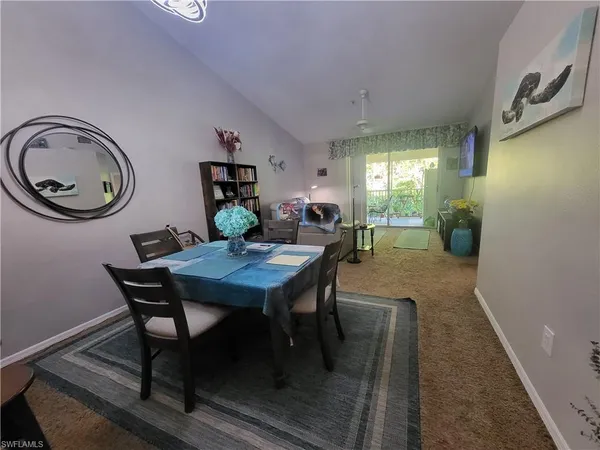a dining room with furniture and chandelier