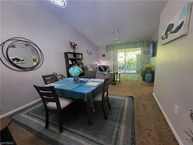 a dining room with furniture and chandelier