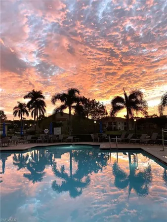 a view of a house with swimming pool and patio