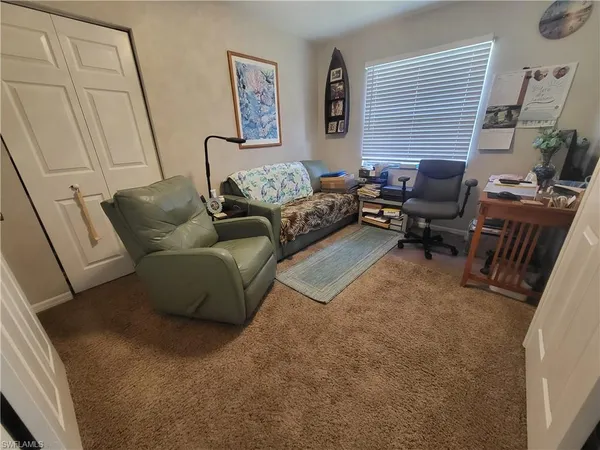 a bedroom with a bed and dresser