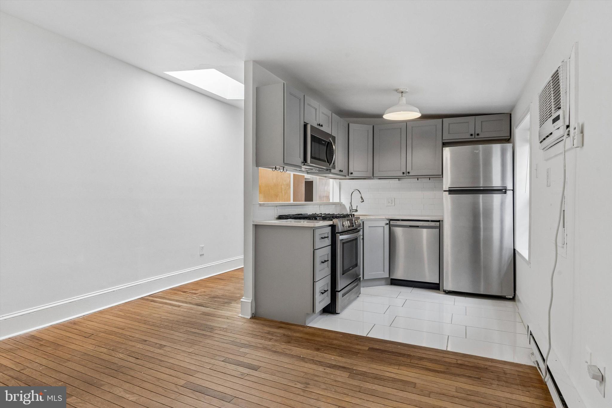 2105 Green Street, Unit 3R Philadelphia, PA 19130 - Photo 5 of 11 a kitchen with a sink a refrigerator and cabinets