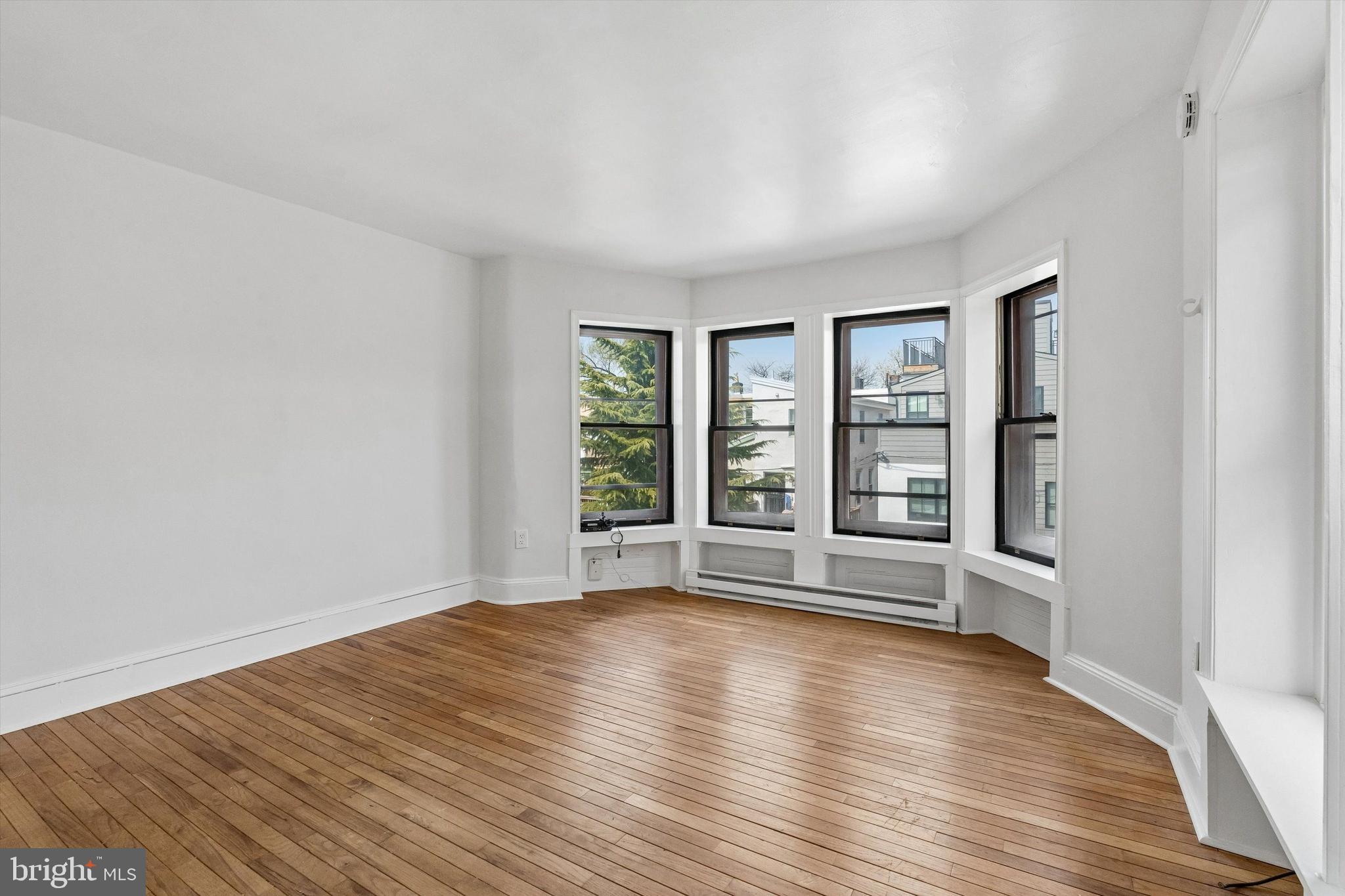 2105 Green Street, Unit 3R Philadelphia, PA 19130 - Photo 9 of 11 wooden floor in an empty room with a window