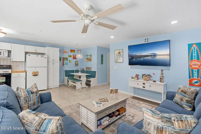 a living room with furniture and kitchen view