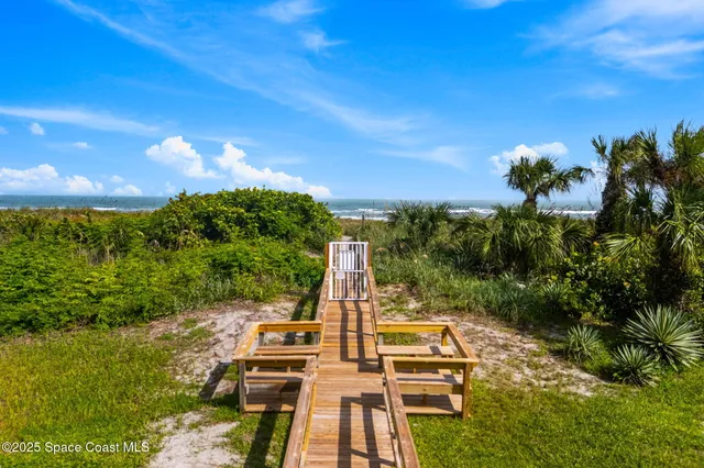 a view of a lake with beach and city space