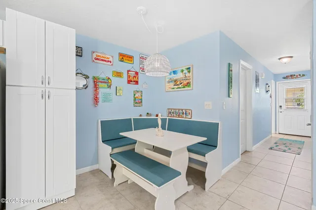 a view of kitchen with furniture and refrigerator