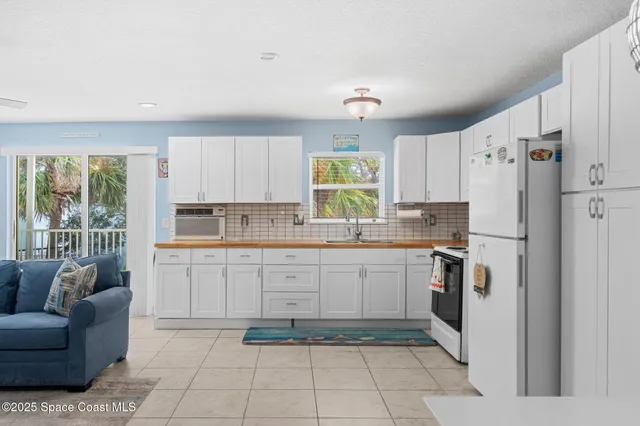 a kitchen with a white stove top oven and refrigerator