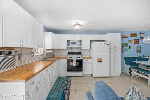 a kitchen with a refrigerator and a stove top oven