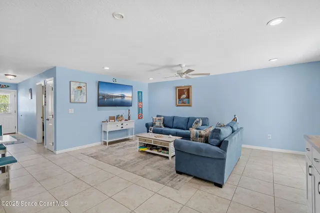 a living room with furniture and a kitchen