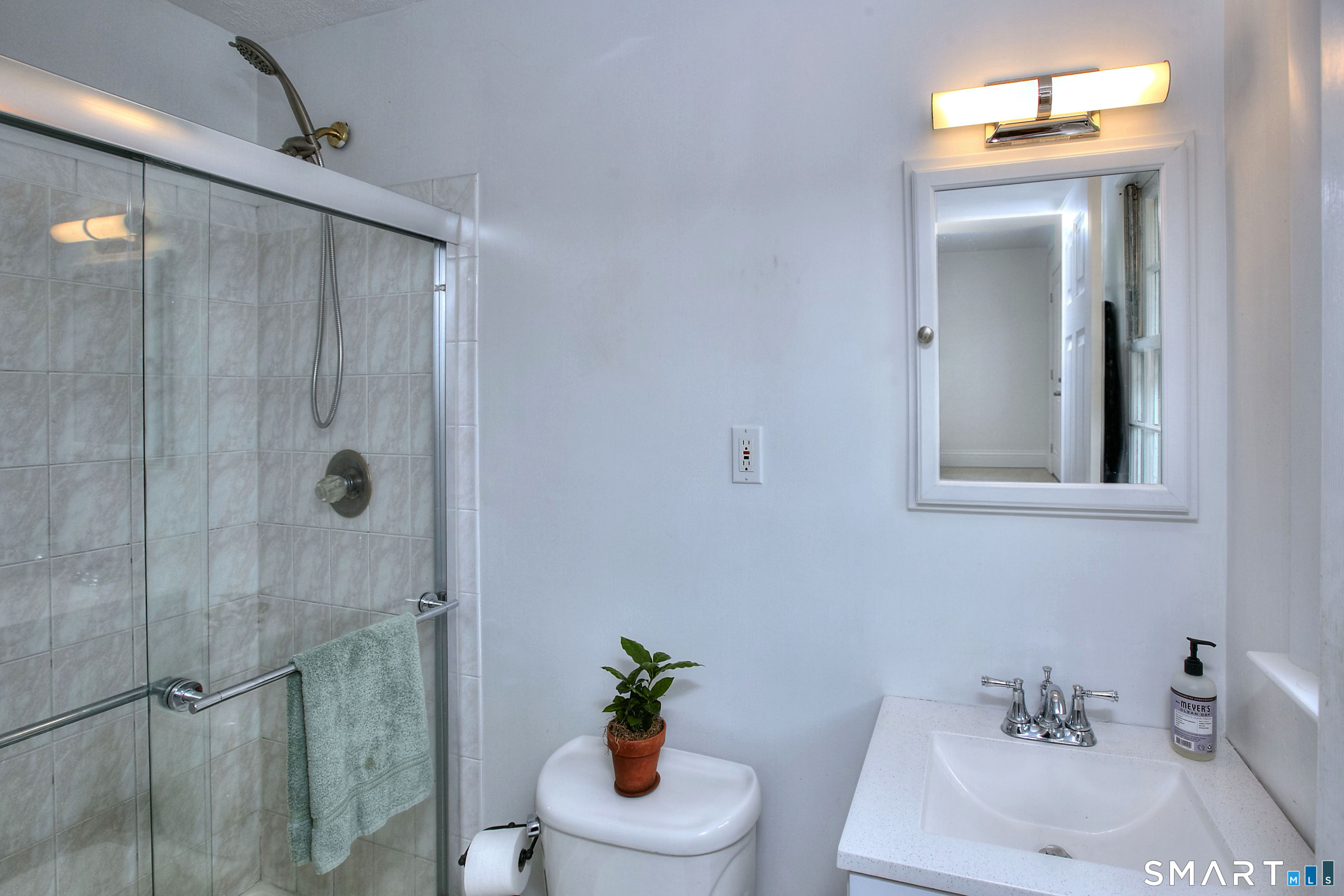 324 Ridge Road Orange, CT 06477 - Photo 26 of 38 a bathroom with a shower a sink a toilet and a mirror
