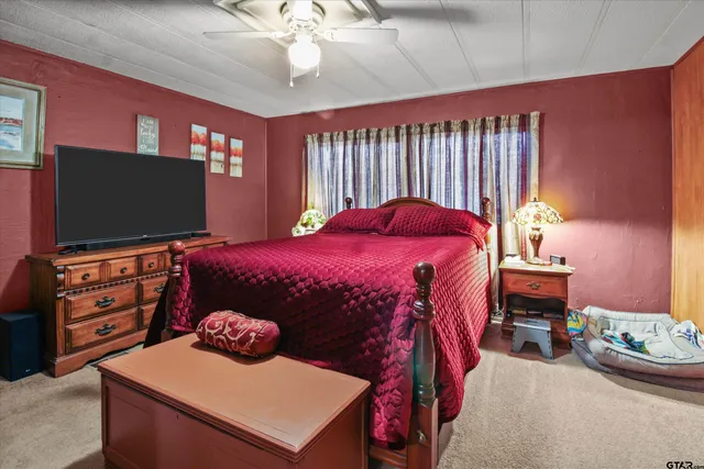 a bedroom with a bed and flat screen tv