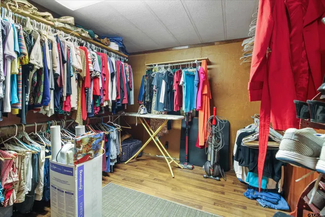 a view of walk in closet with clothes