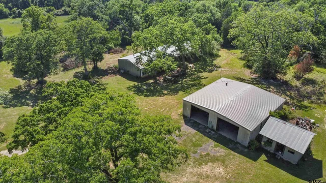a view of a house with backyard porch and sitting area