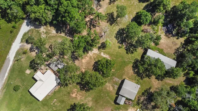 an aerial view of a house with yard swimming pool and outdoor seating