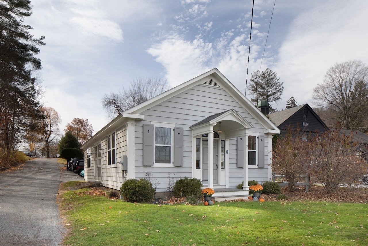 a front view of house with yard and green space